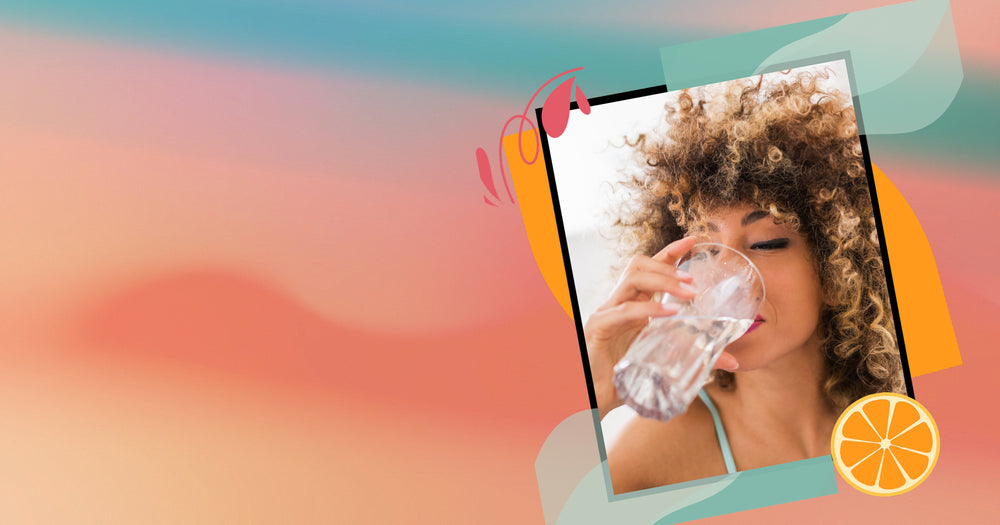 Woman drinking from a glass with a colorful abstract background and an orange slice.